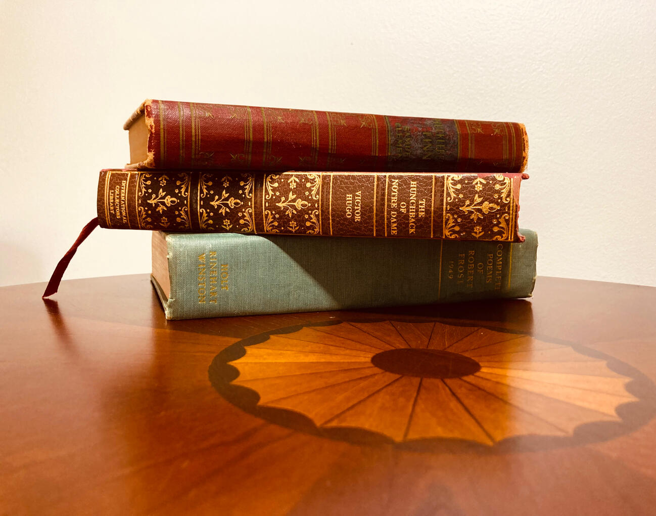 Books on a Table Three Books Stacked on a Round Table