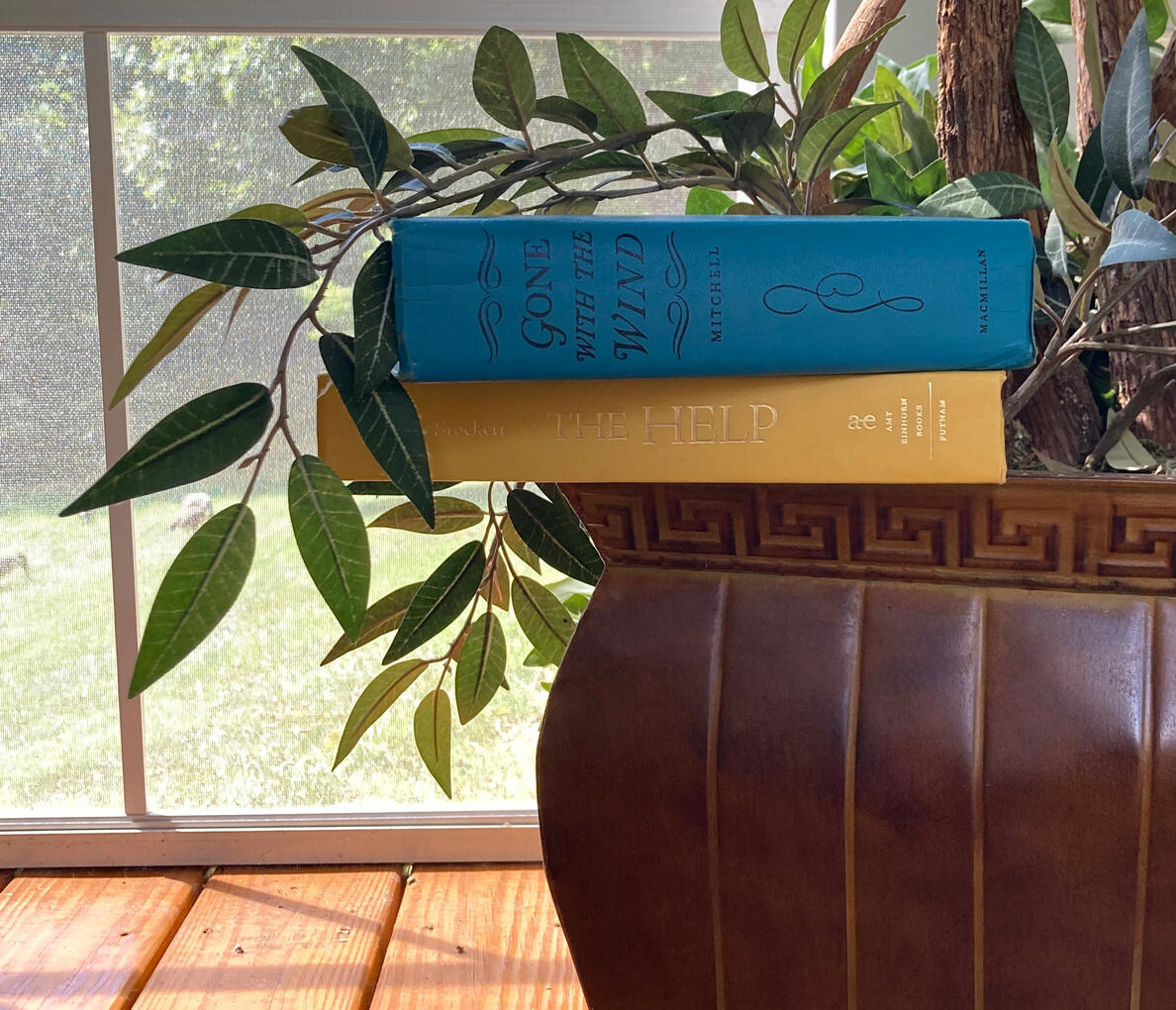 Books Sitting on a Planter Two Books Sitting on the Edge of a Planter