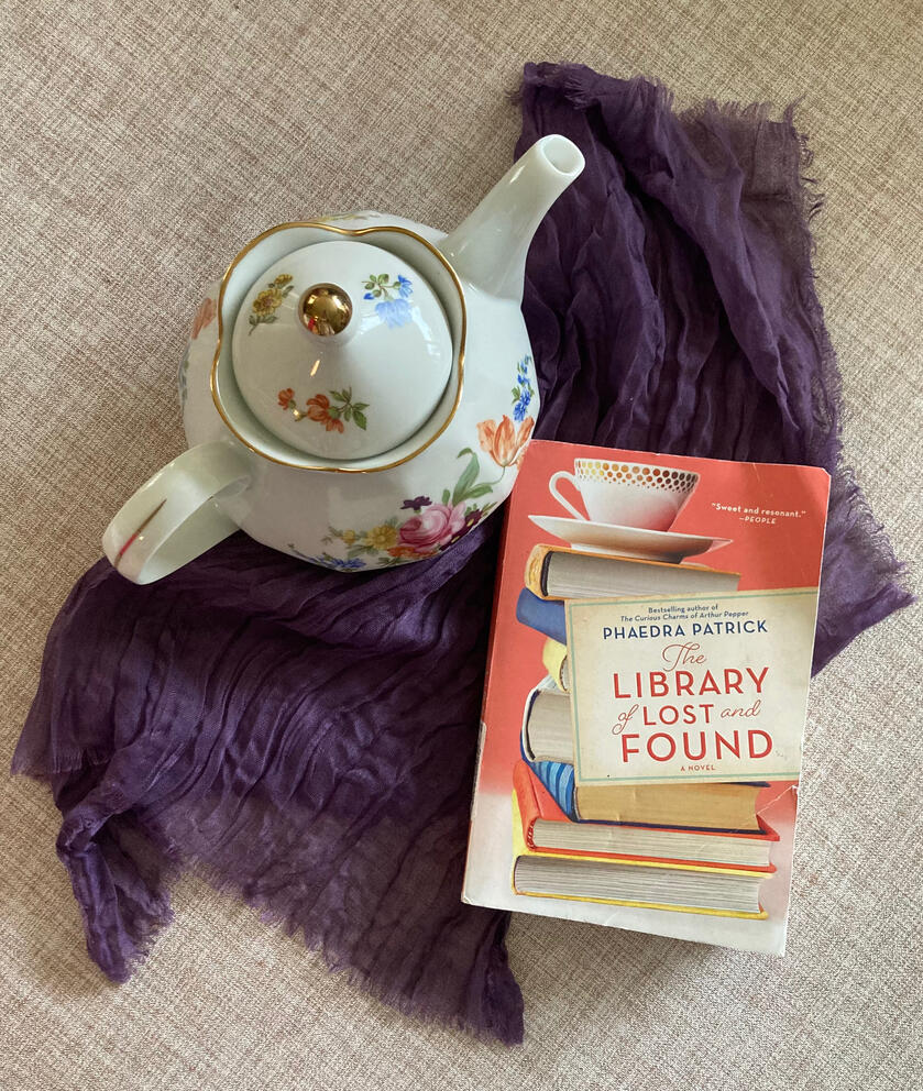 Teapot with Book Teapot on a tablecloth, next to a book titled "The Library of Lost and Found"